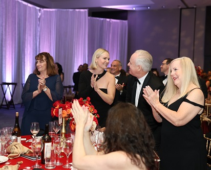 Four guests standing and clapping